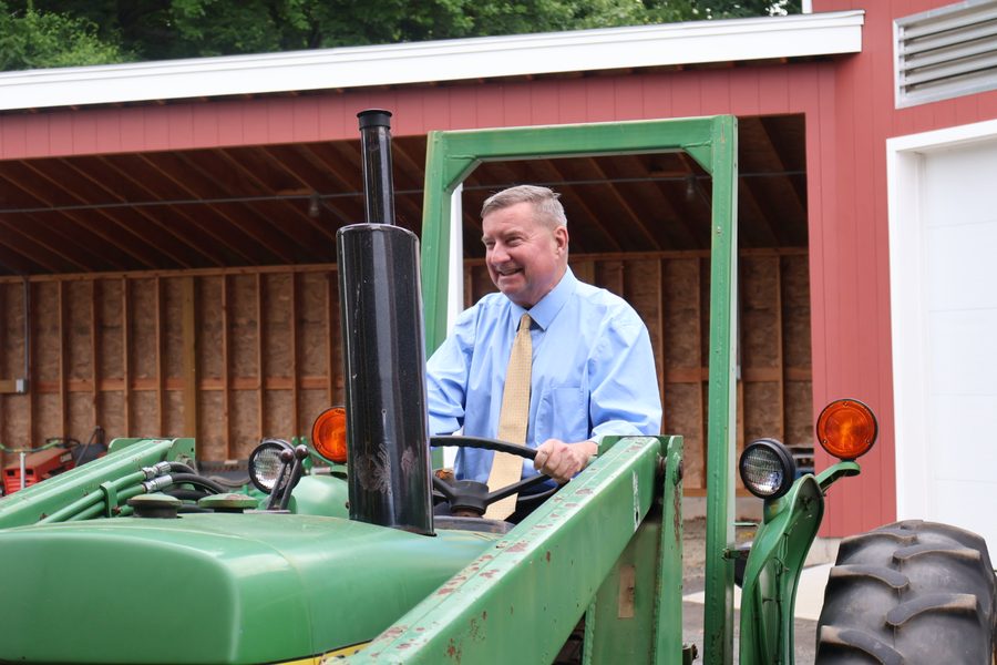 Senator Kissel seated on a tractor at a local farm